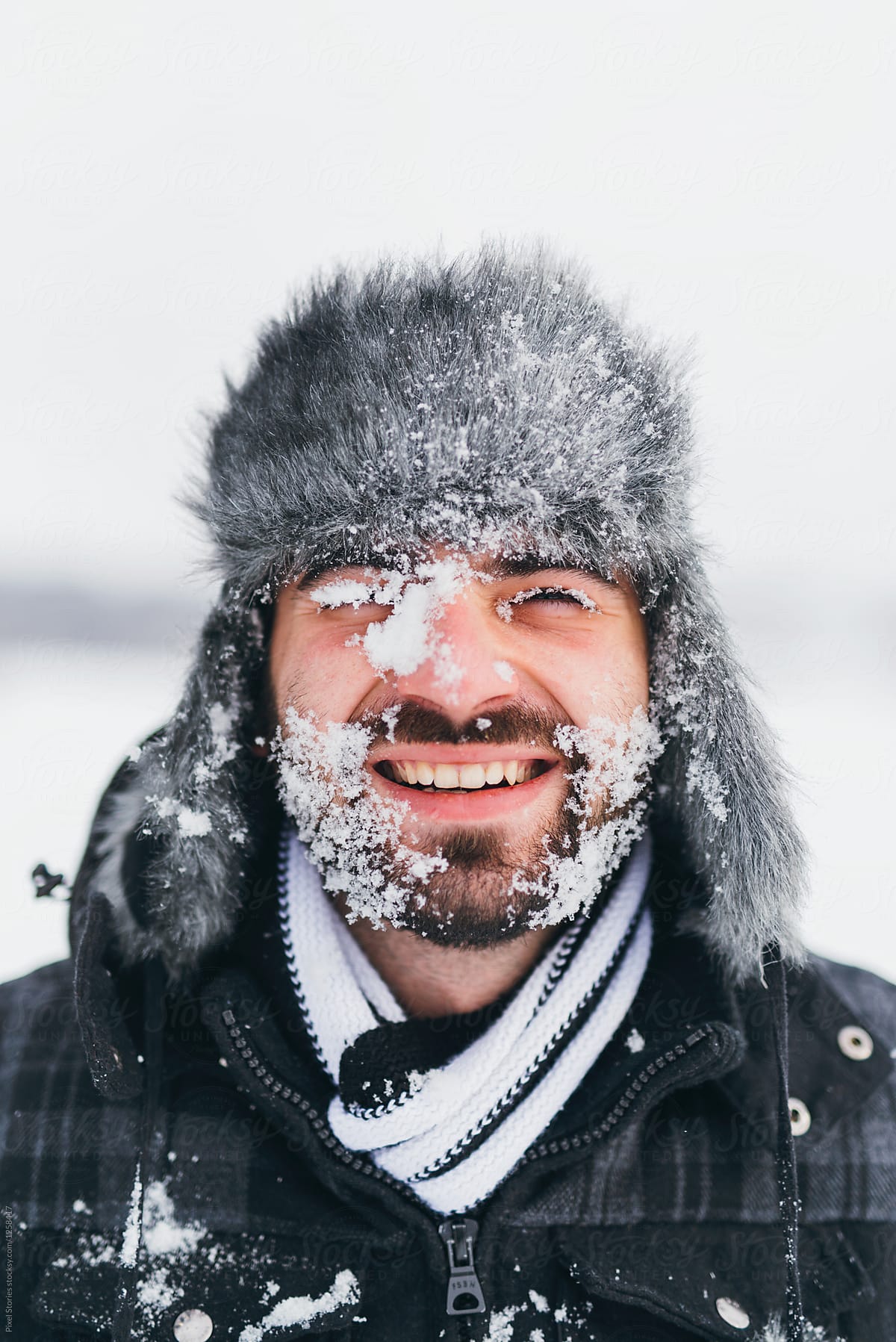 Young man smiling with snowy face