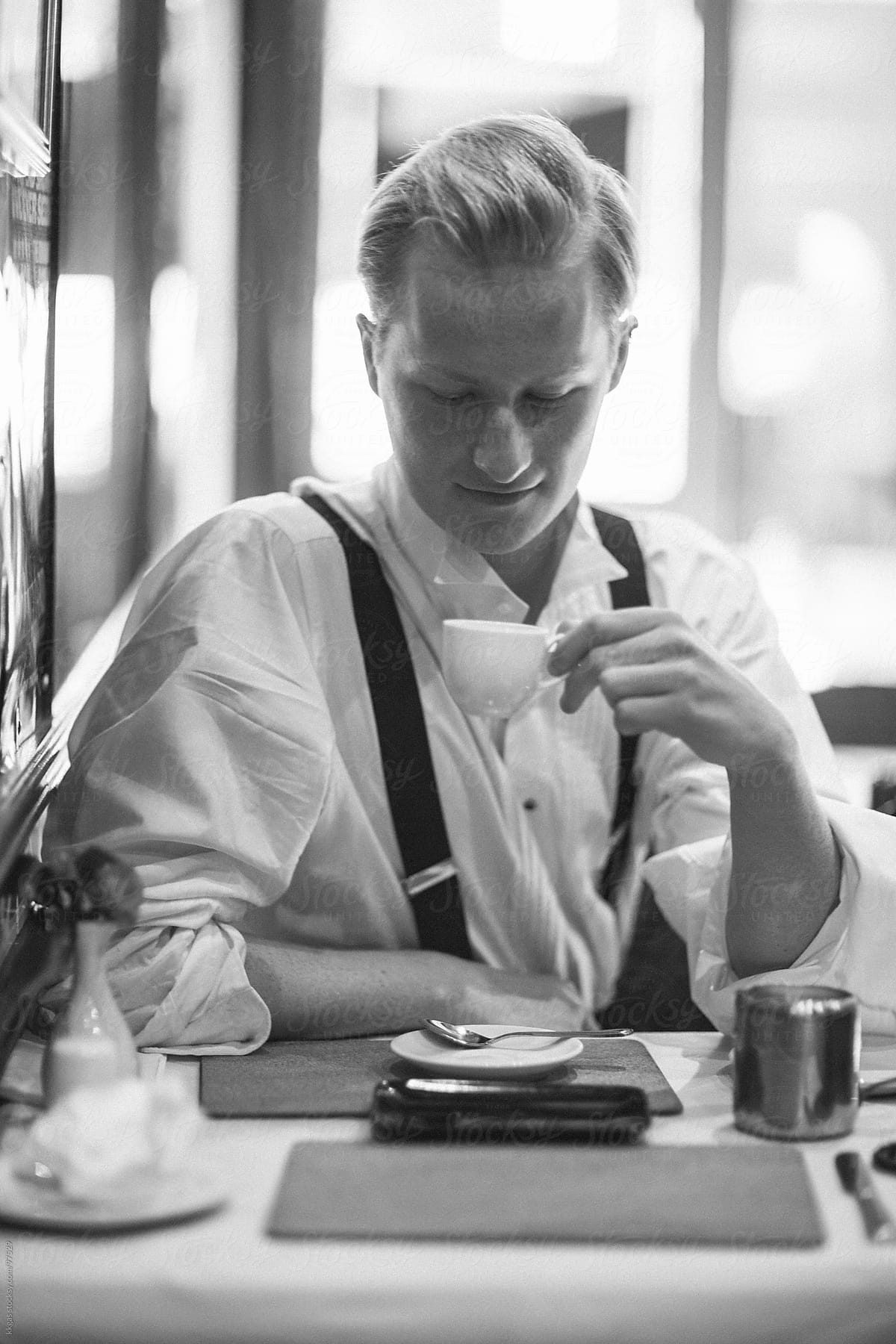 Young man drinking coffee in a restaurant