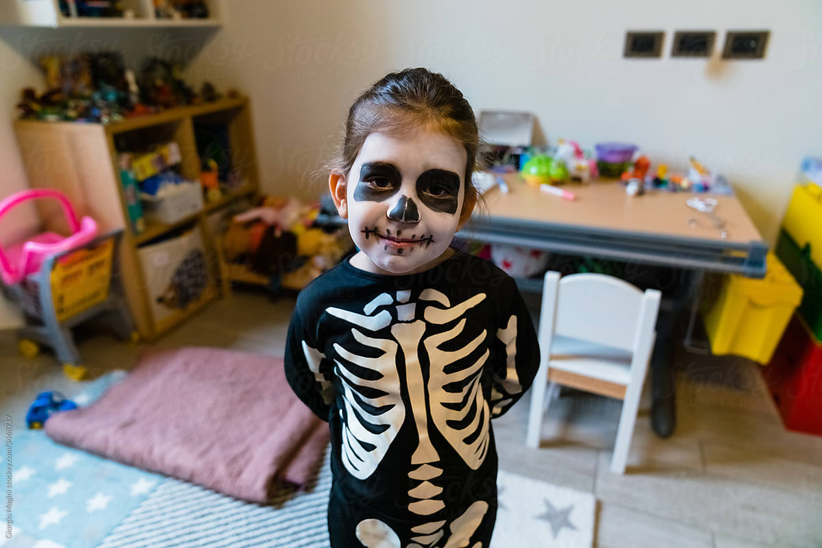 Cute girl in Halloween costume in playroom