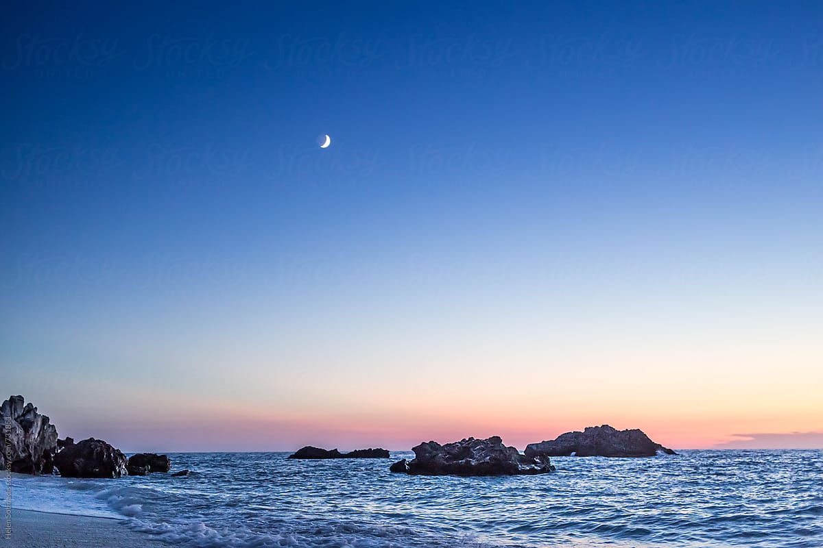 Rocky Seascape with Crescent Moon at Twilight