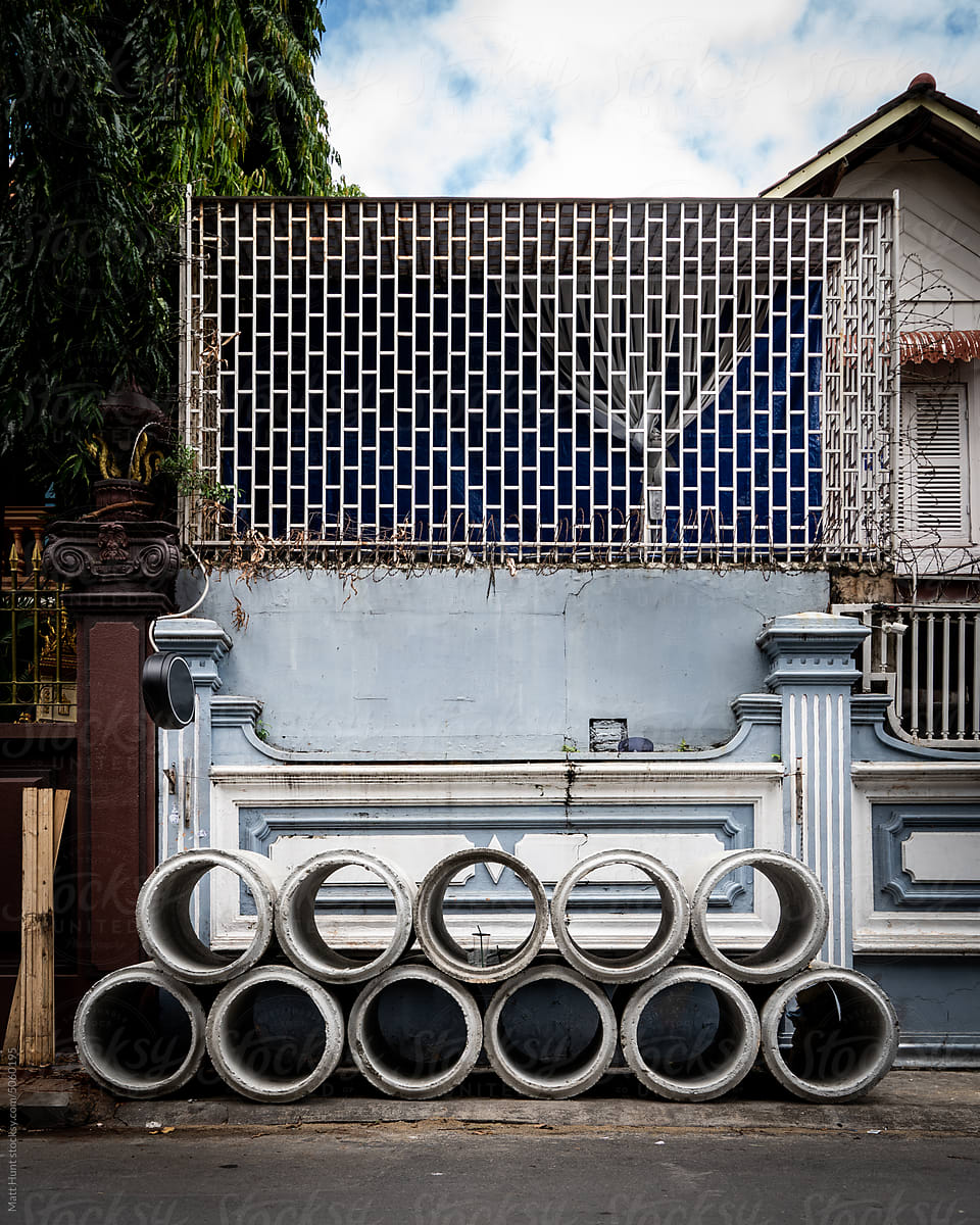 A stack of large concrete pipeline pieces on the street in Cambodia