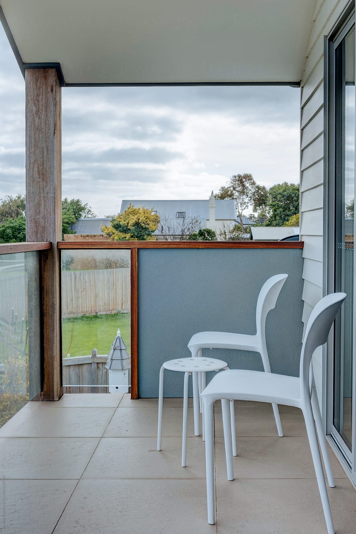 Elevated first floor balcony with modern resin chairs