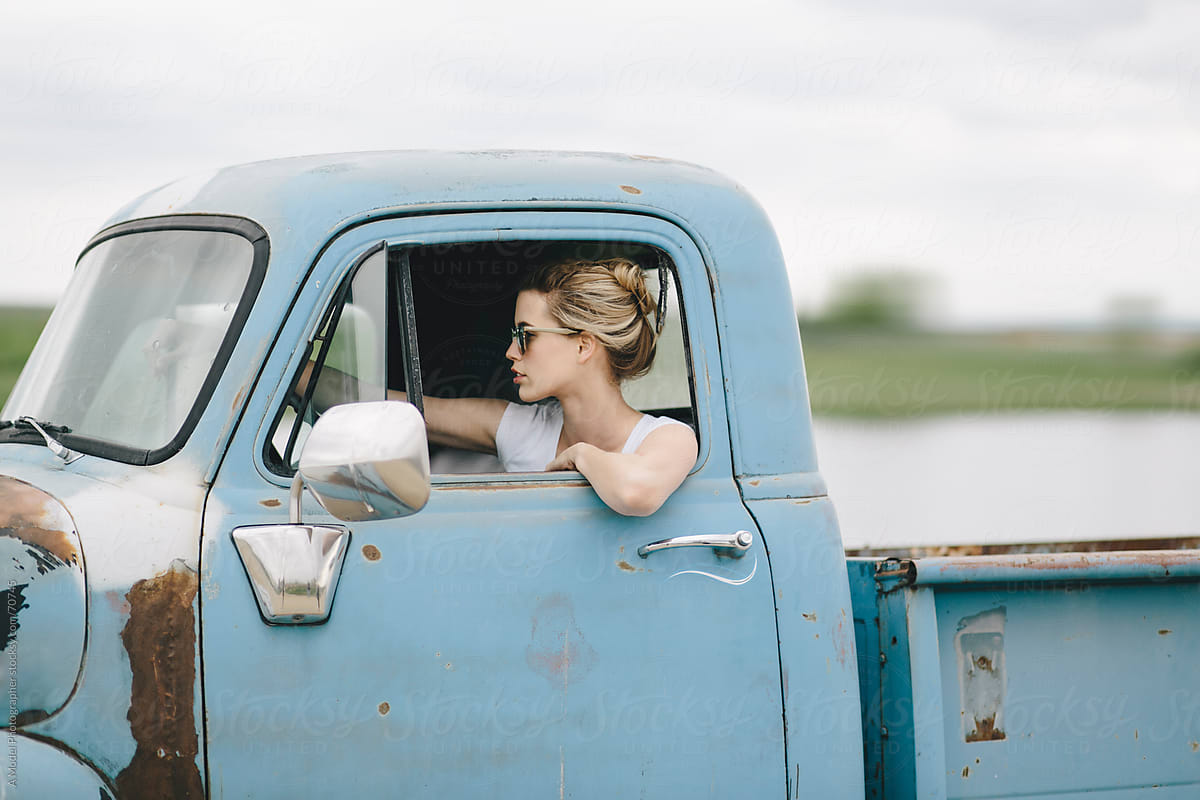 Blond girl  driving an old  pickup  truck  by Ania Boniecka 