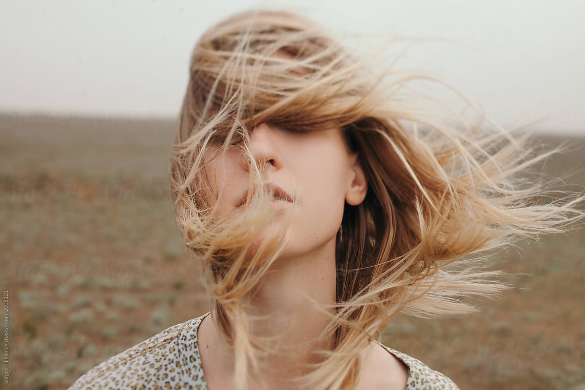 Carefree woman portrait with wind
