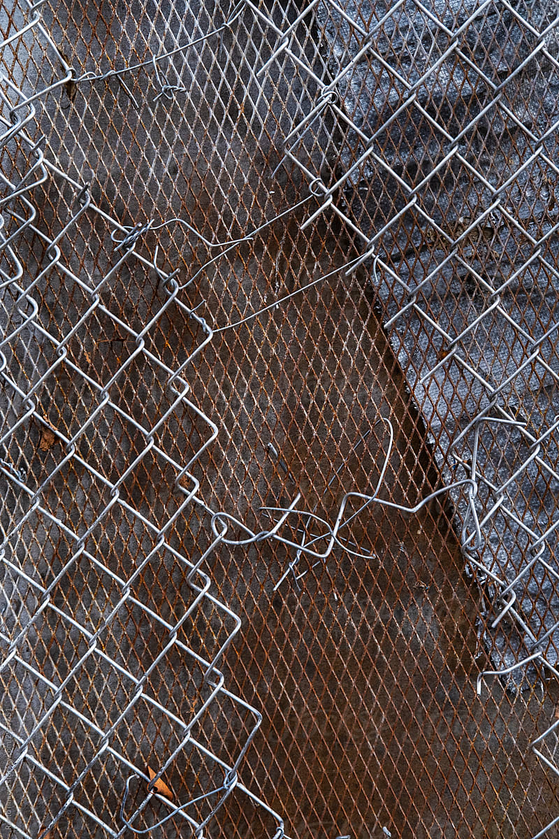 Close up of broken metal chain link fence