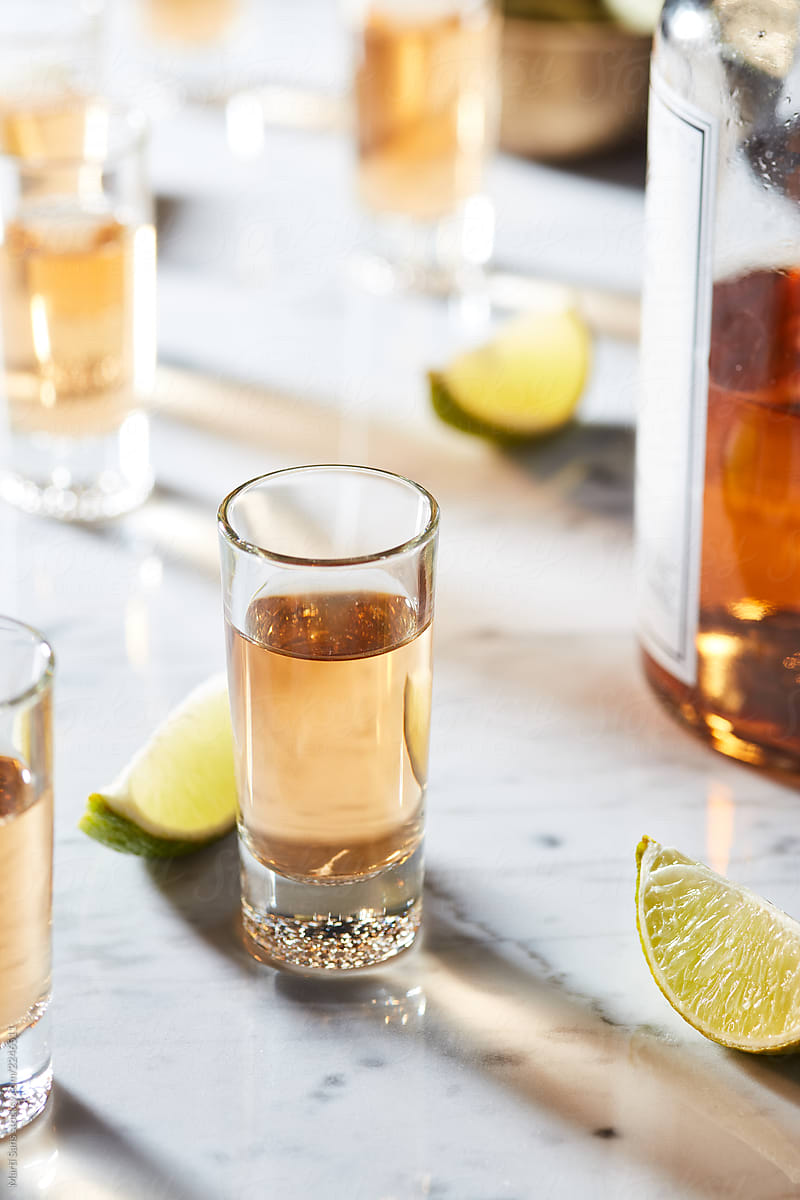 Shots of tequila on table.