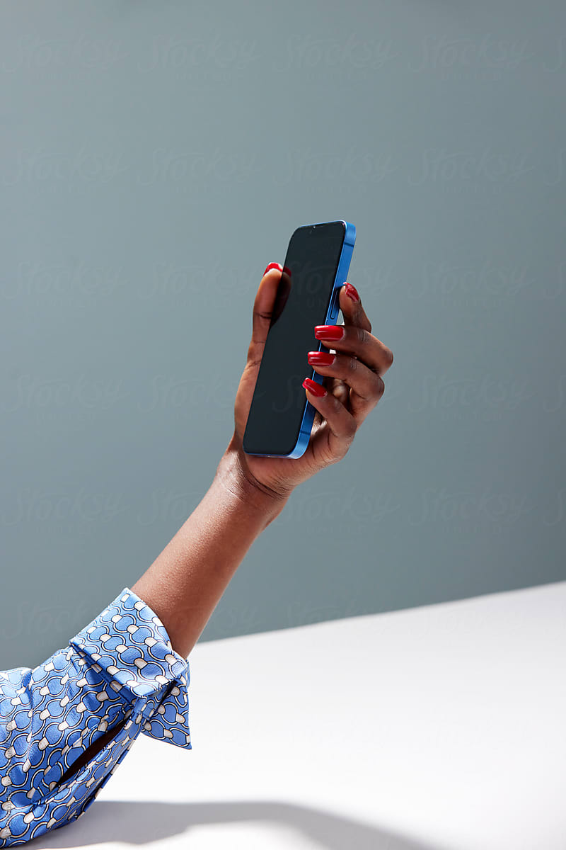 Cropped image of black woman watching social media on smartphone