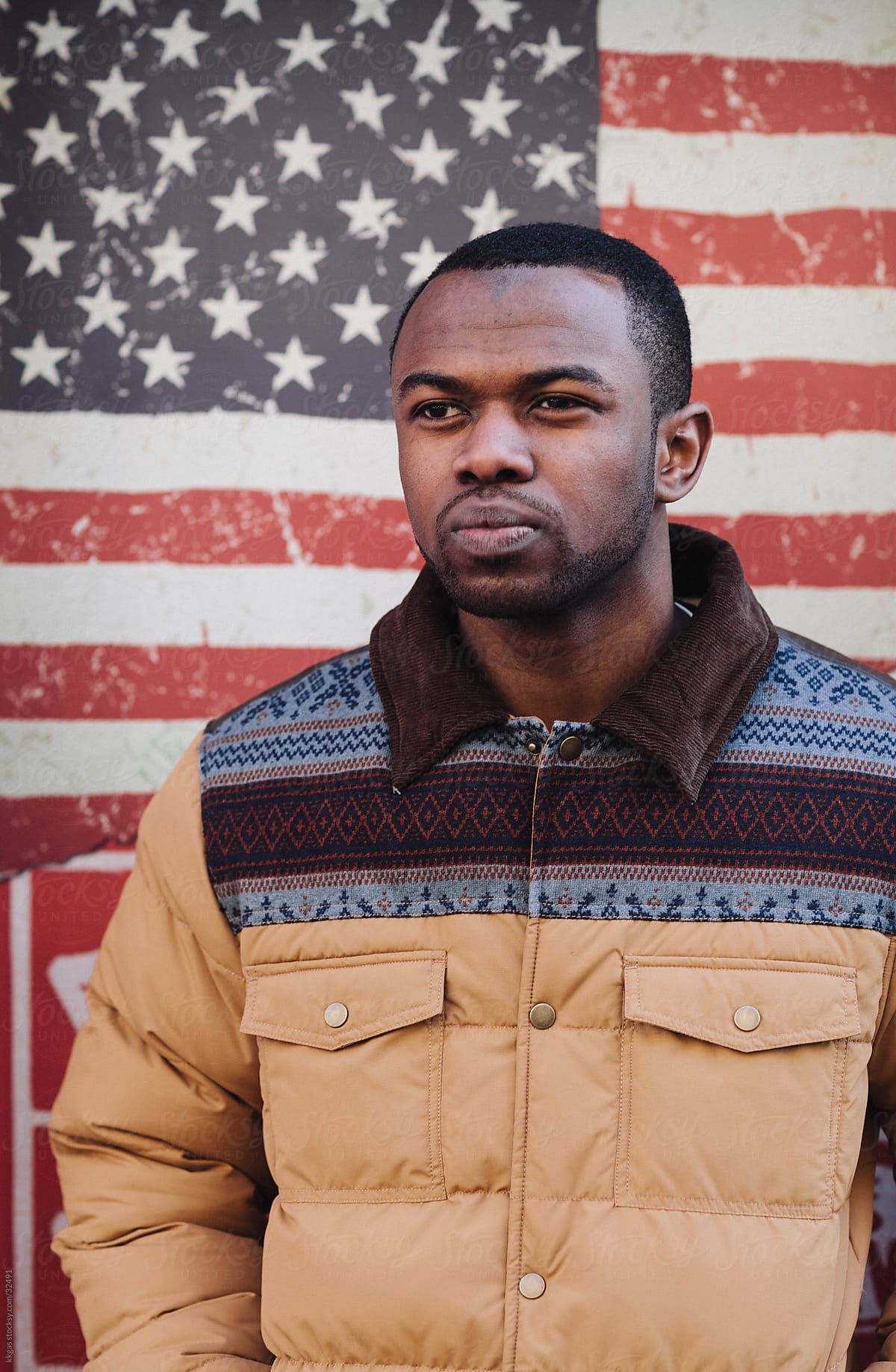 Young man standing in front of an American flag