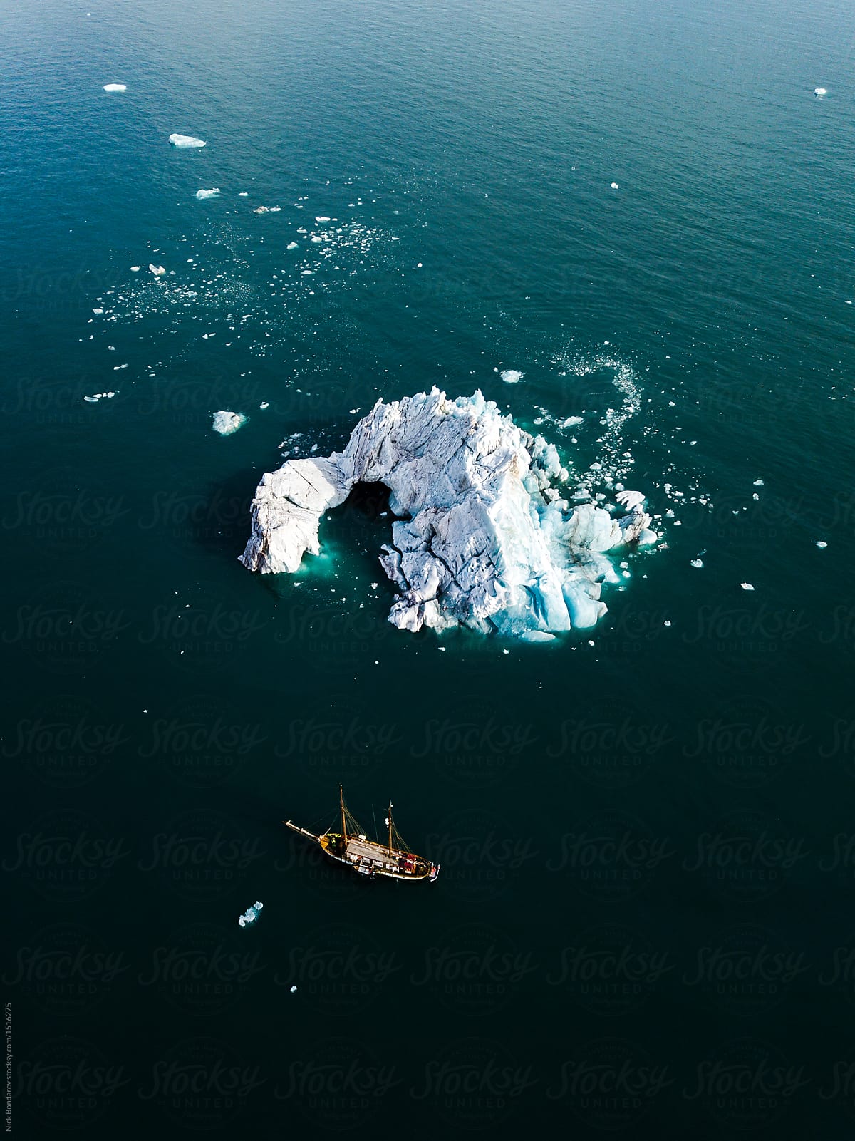 Aerial drone shot from above of Icebergs floating in the arctic close to greenland