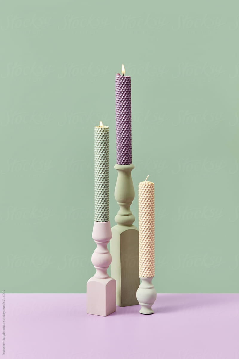 Handmade beeswax candles in pastel colors.
