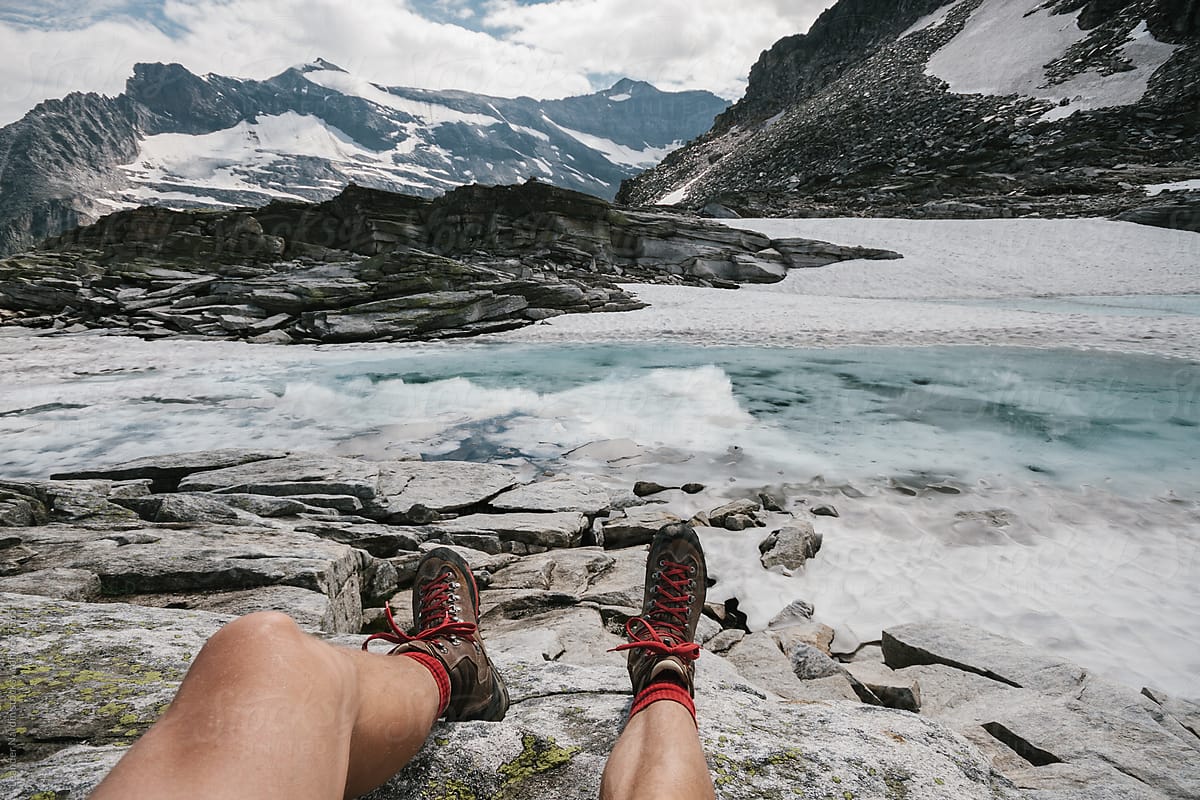 detail of relaxing male hiker´s feet in a glacier landscape