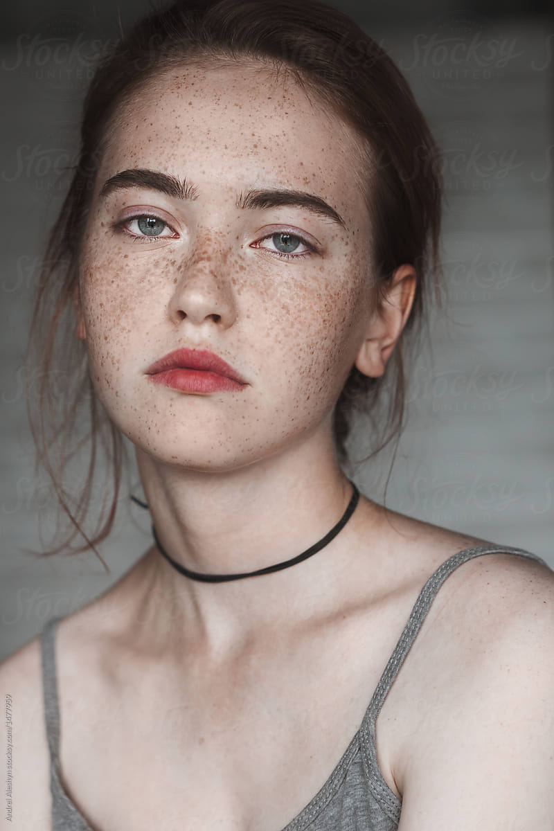 Closeup portrait of adorable girl with lots of freckles 