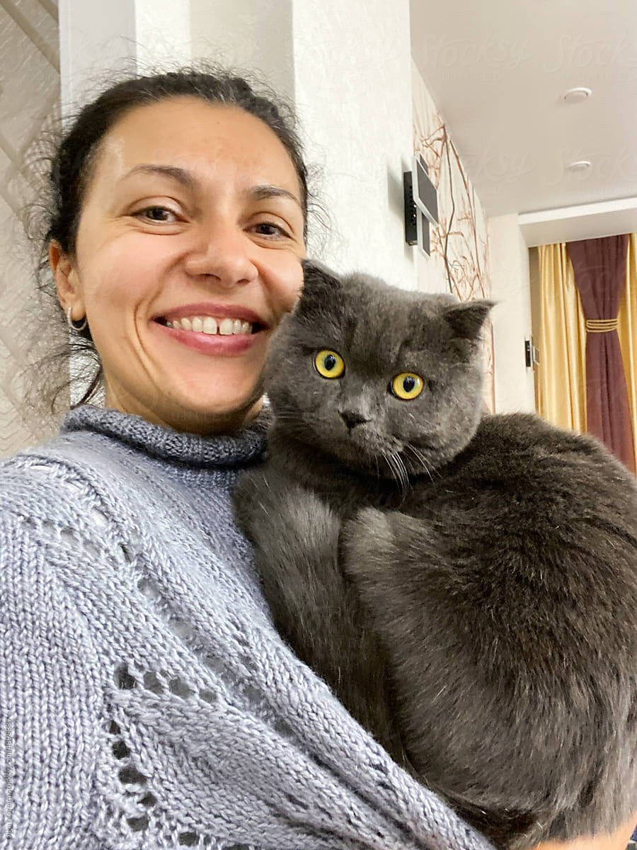 Selfie of a woman holding a cat