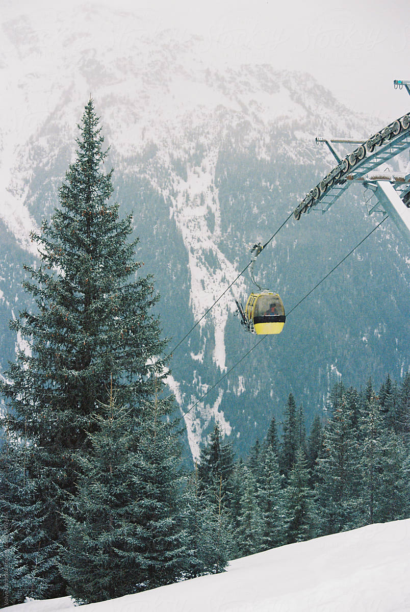 Cable car opposite mountains and forest