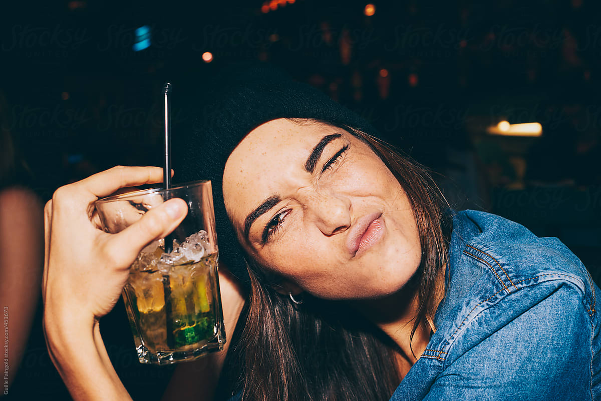 Young lady with cocktail making face