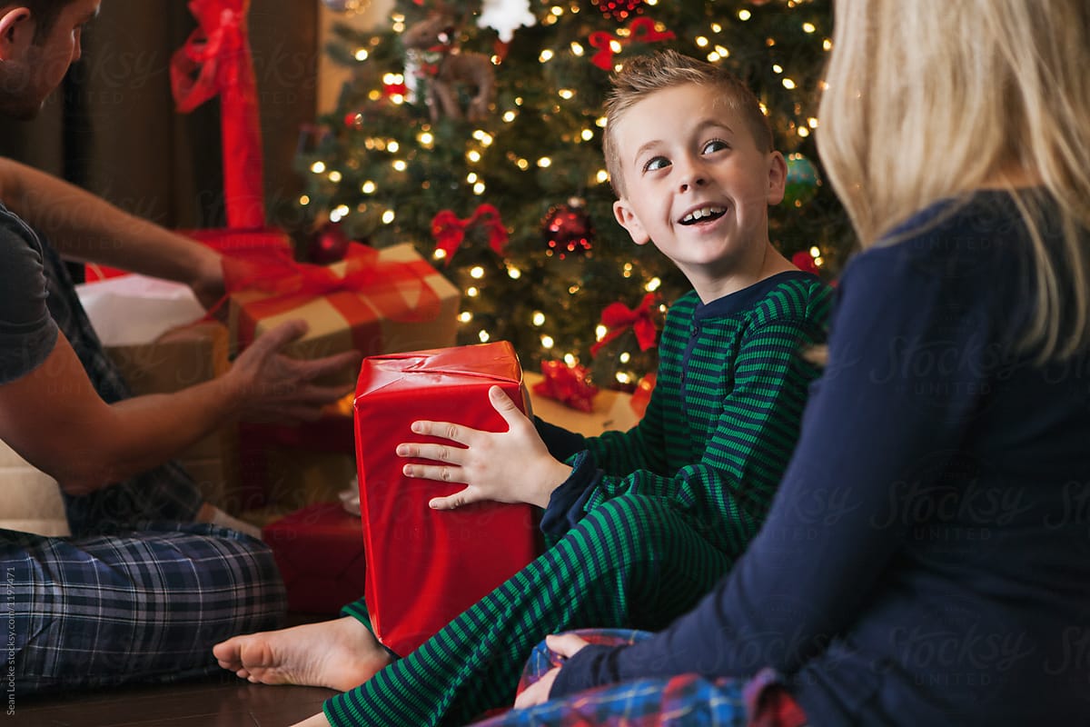 Christmas: Young Boy Excited To Open Christmas Gift