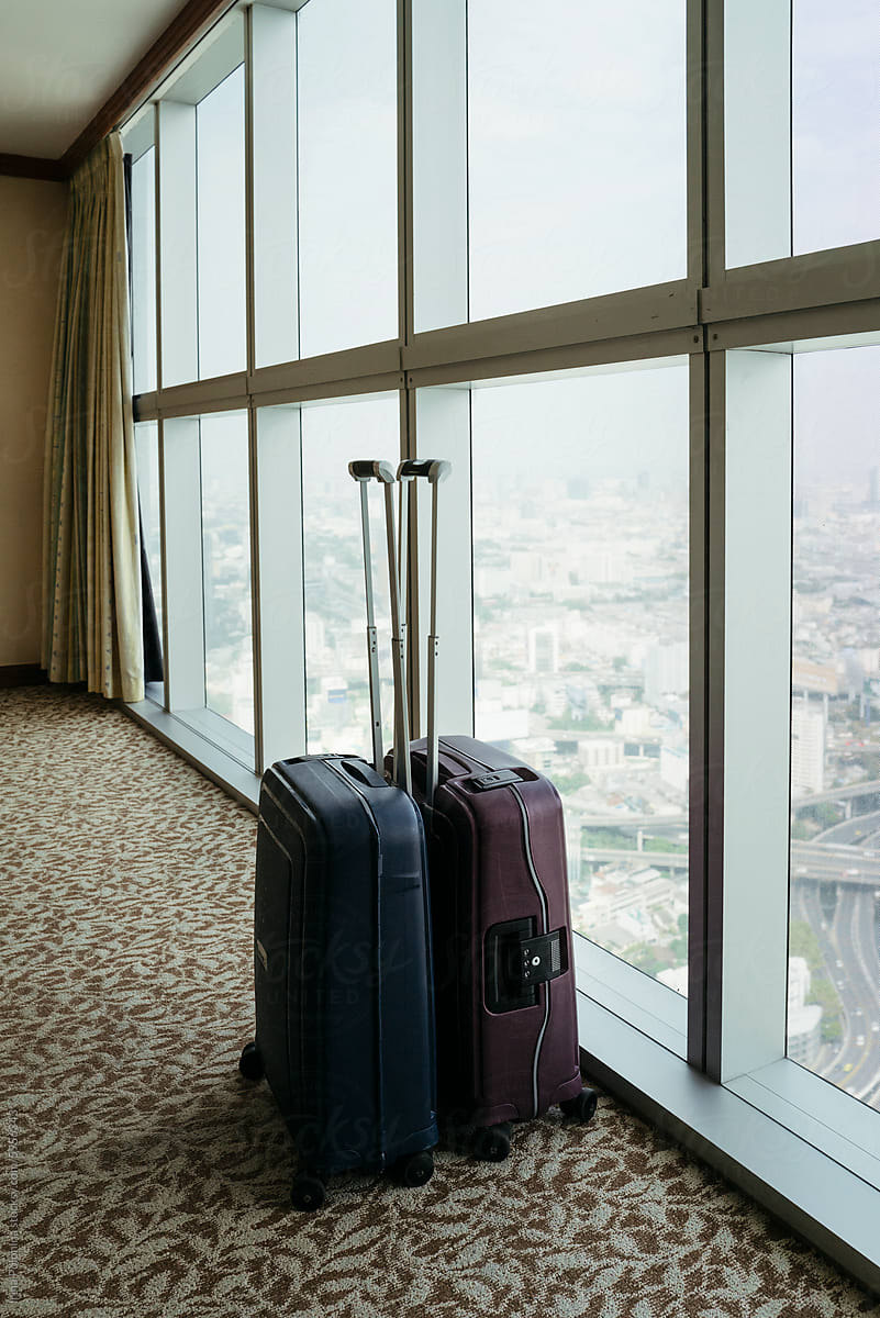 Luggage by Hotel Room Window Overlooking City