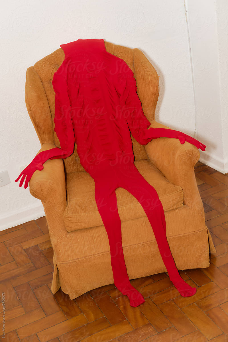 Red clothes styled as a human body in an armchair