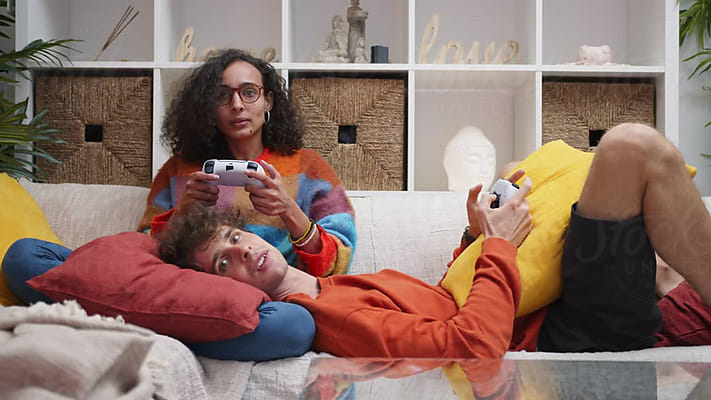 Gaming On Couch by Stocksy Contributor Atolas - Stocksy