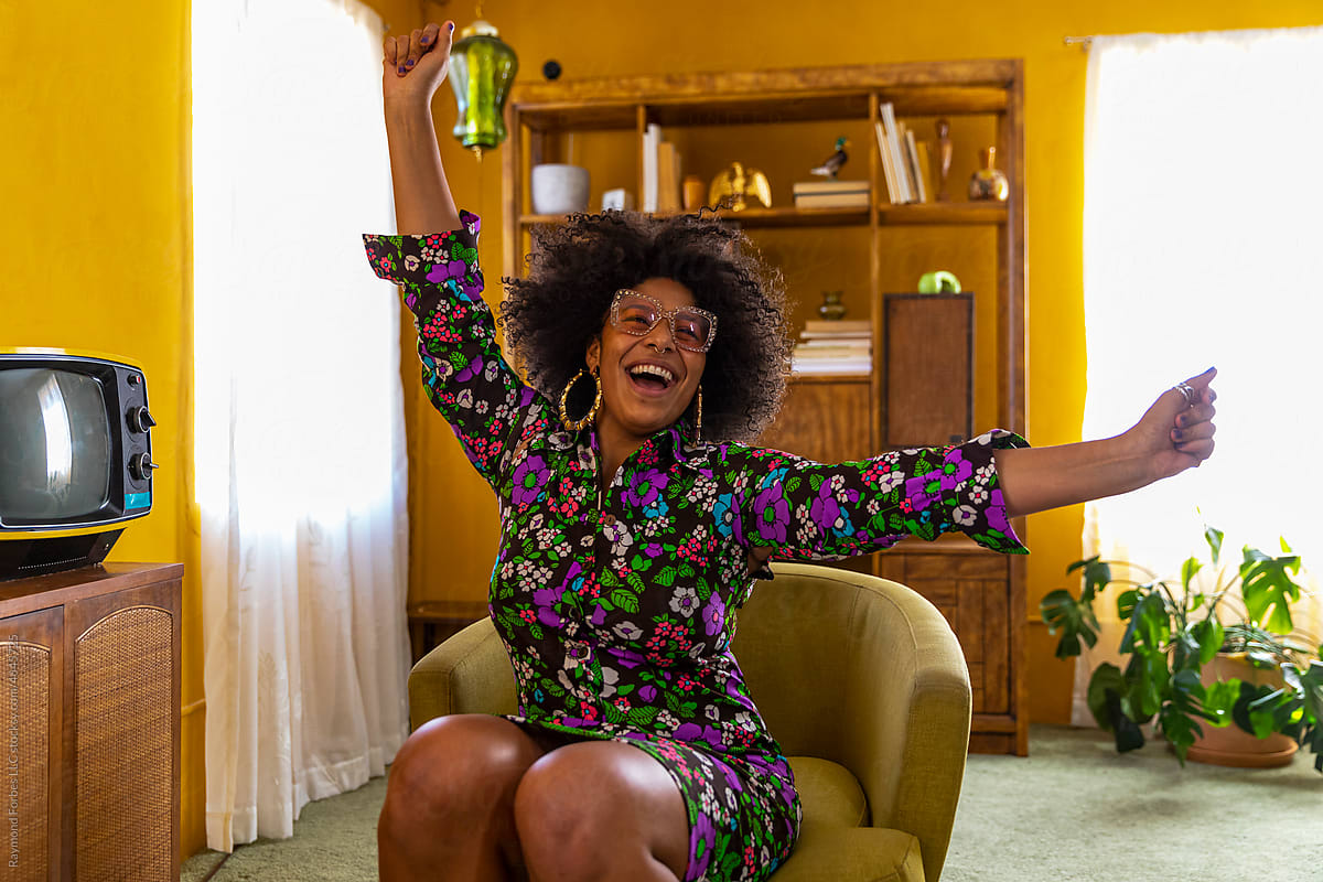 Excited Young Black woman portrait with arms raised