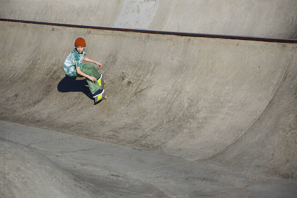skater riding on concrete ramp