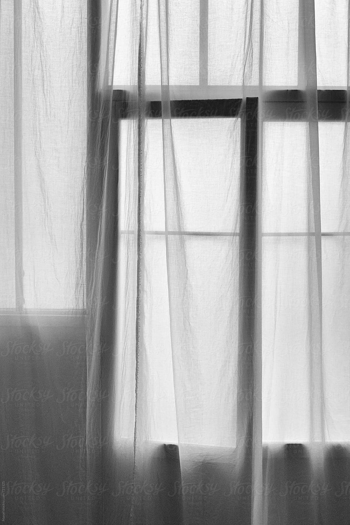 Black and white image of curtains and window