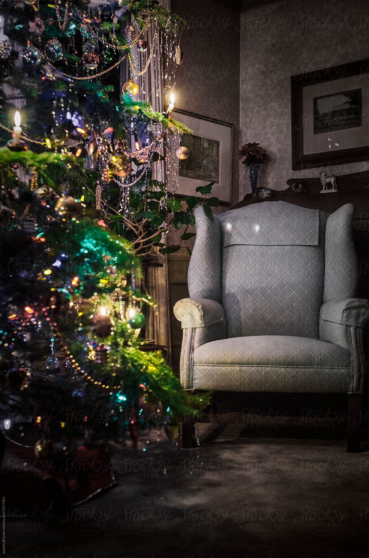Armchair and Christmas Tree Decorated and Lighted with Traditional Wax Candles