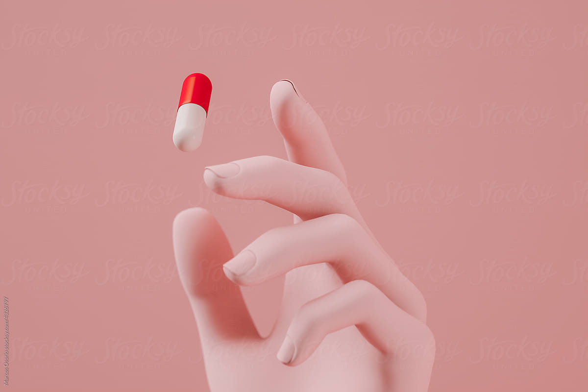 Hand picking up capsule pill