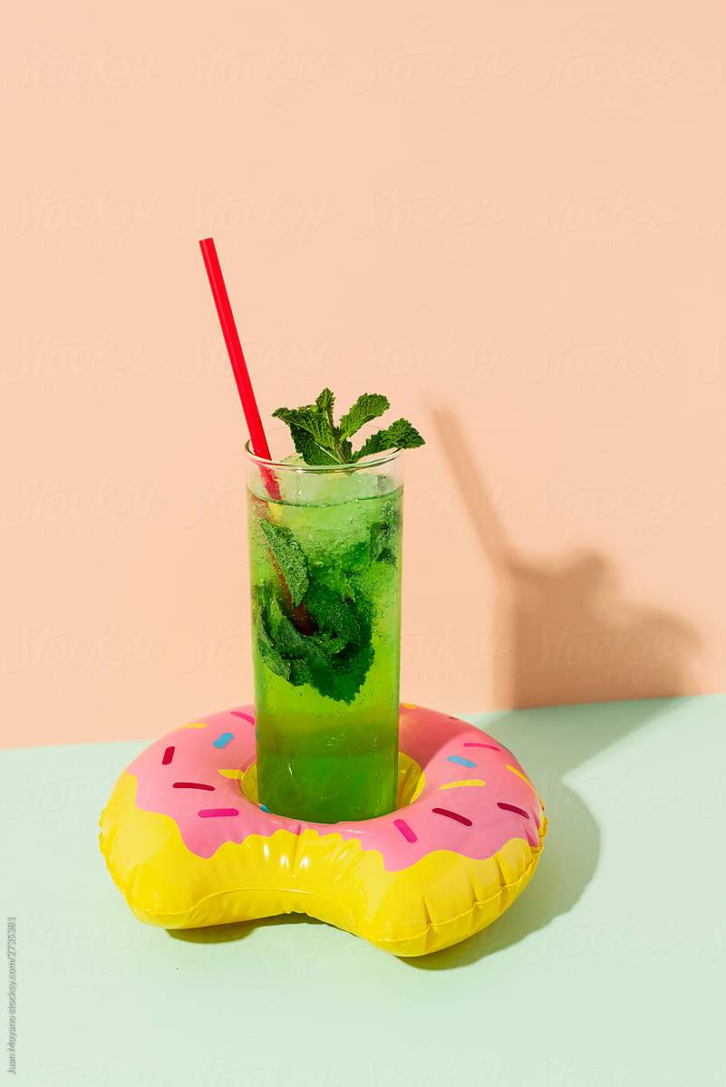 swim ring in the shape of a donut with a cocktail