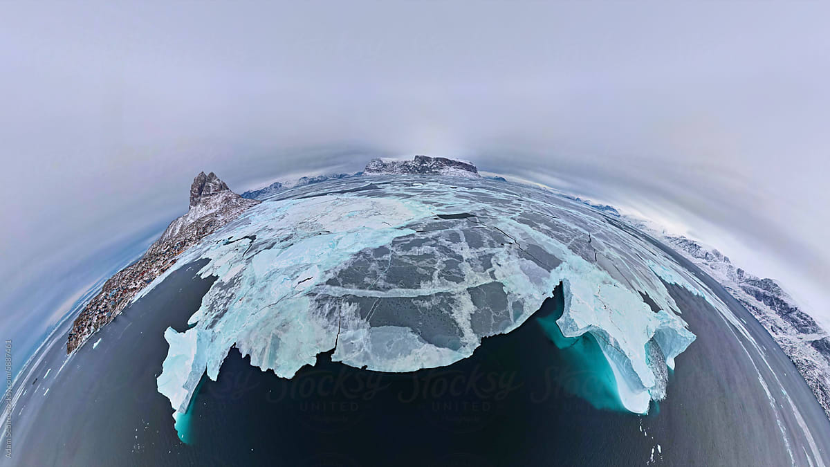 Sheet of sea ice and floating icebergs - Arctic Circle tiny planet