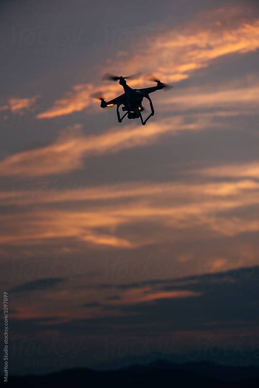 Aerial drone flying against clouds