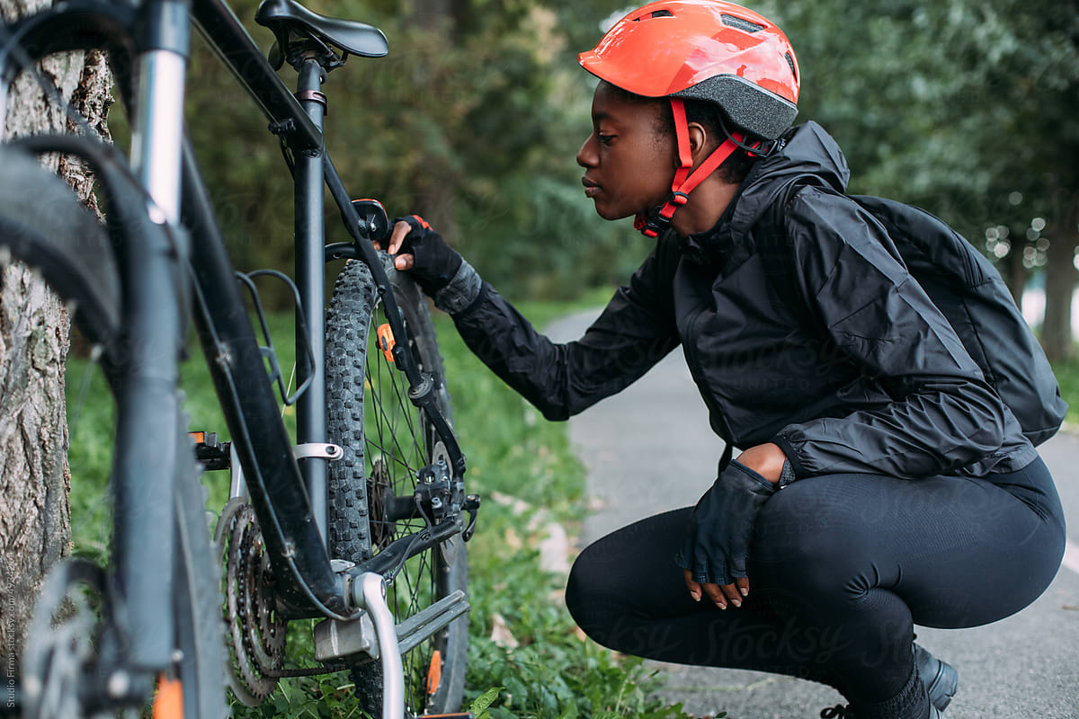 Woman Checking Bicycle Tire