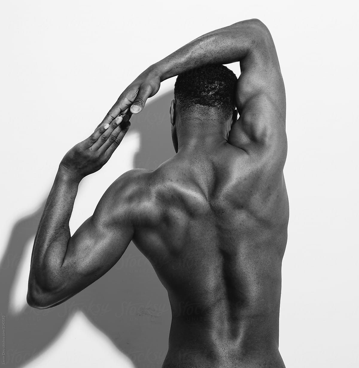 Rear View Of Young Man With His Arms Stretched Out Isolated On