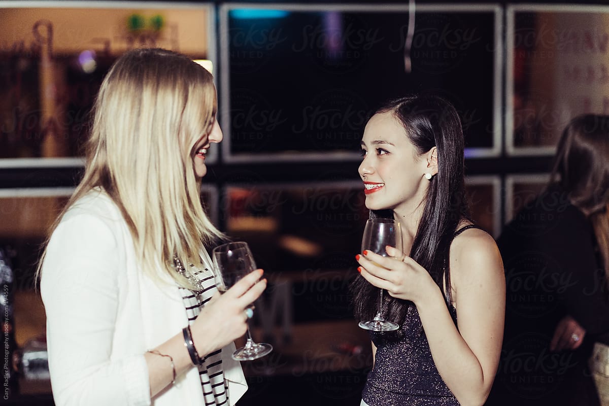 Young Women in Conversation at a Party or Bar