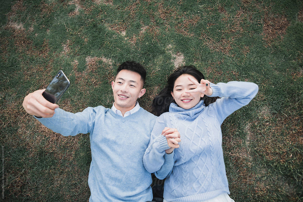 A Chinese couple playing on the lawn