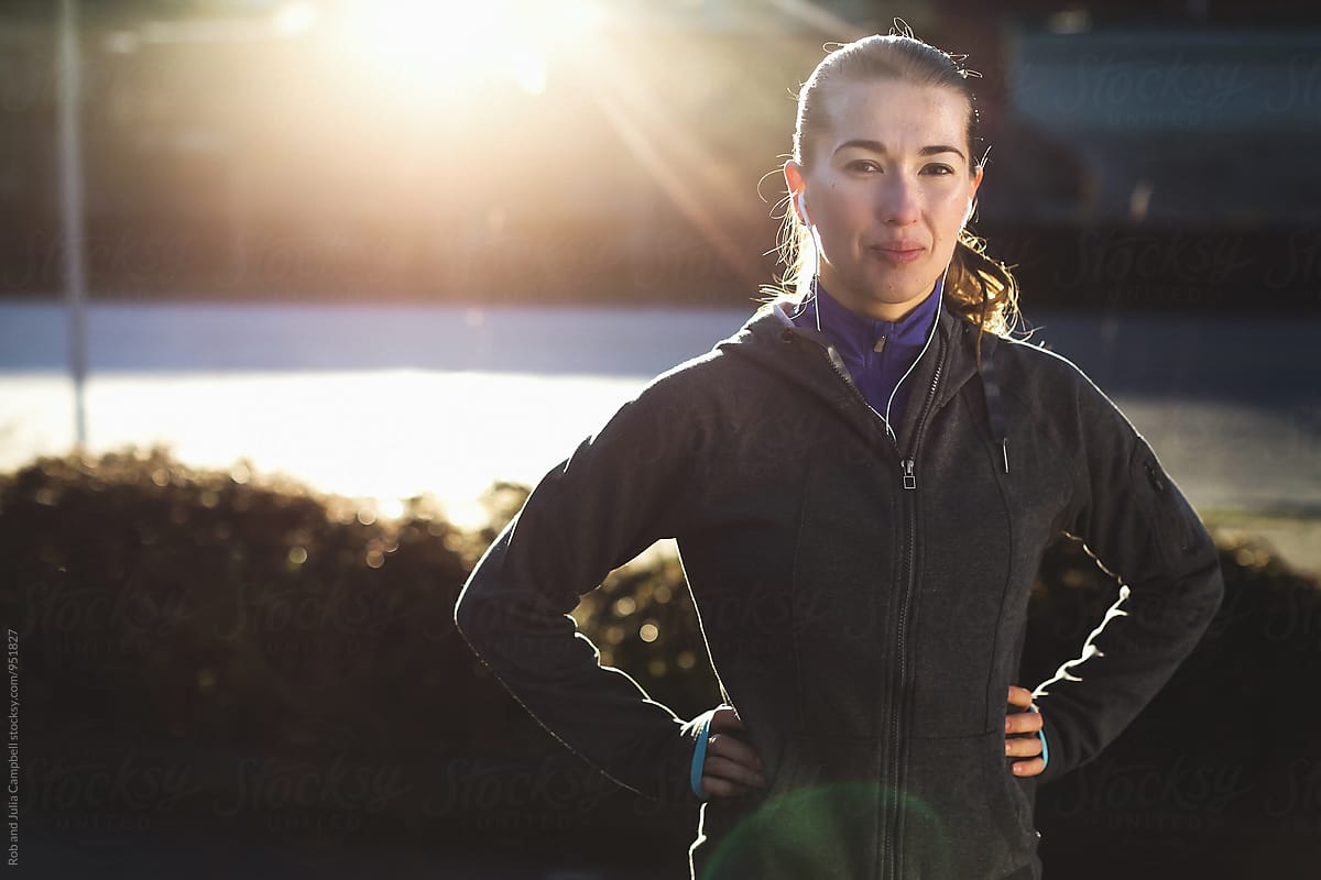 Portrait of young, healthy caucasian woman in running gear outside