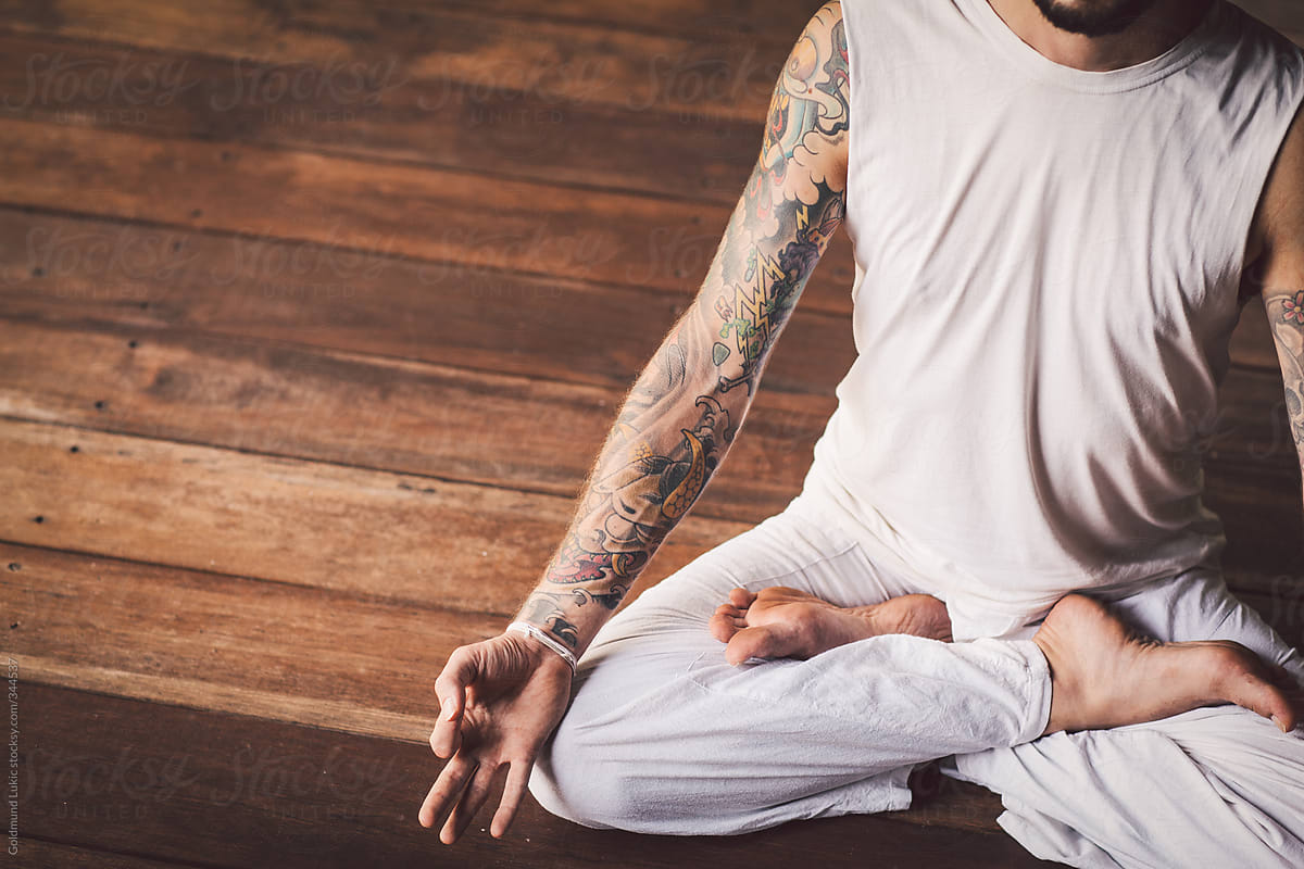 Tattooed Man Meditating in the Lotus Pose (Padmasana)
