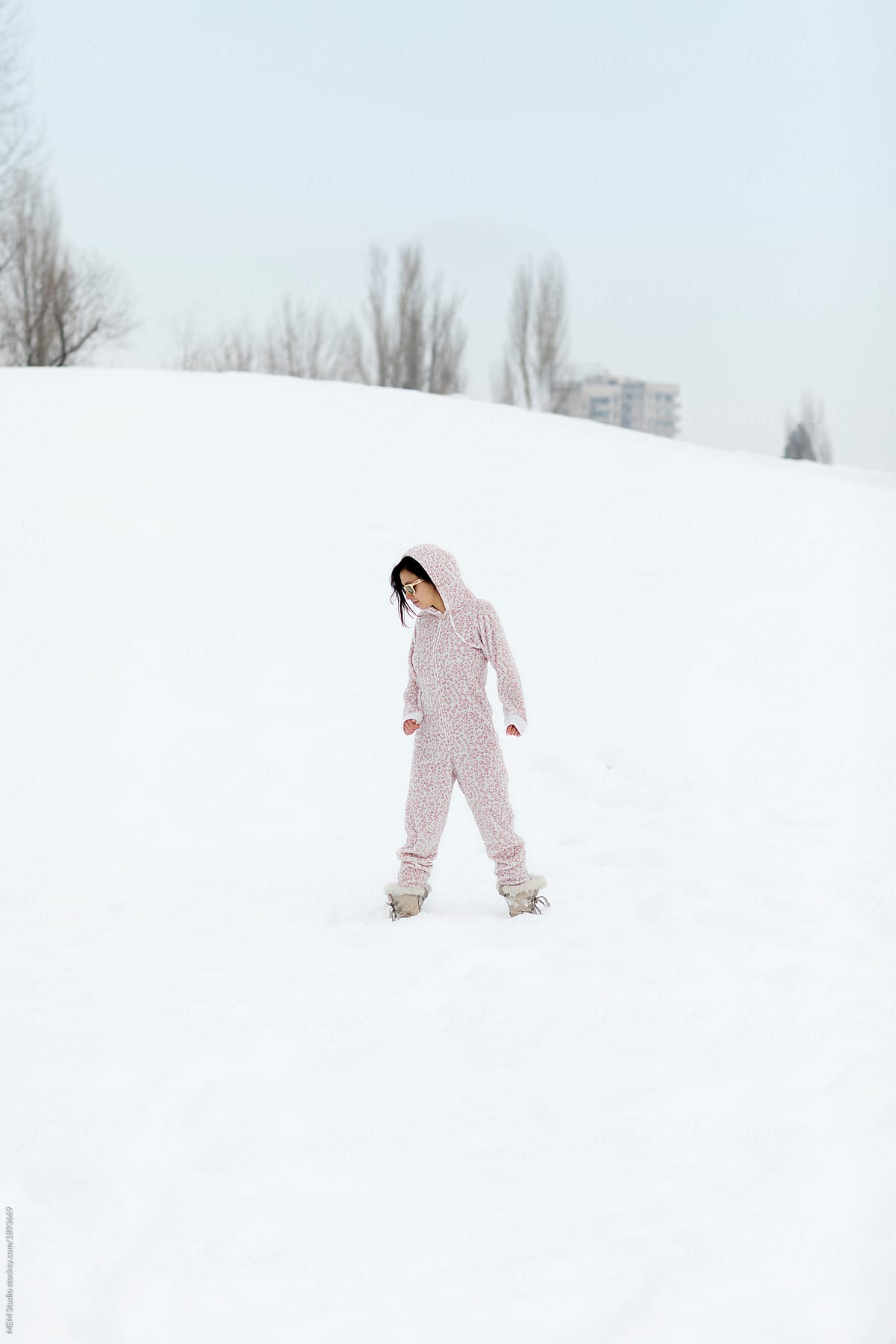 Beautiful woman in the snow wearing onesie
