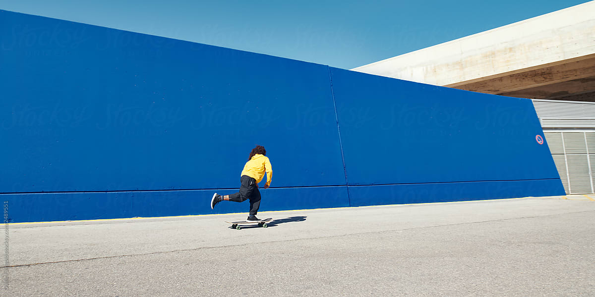 Contemporary man skateboarding on street