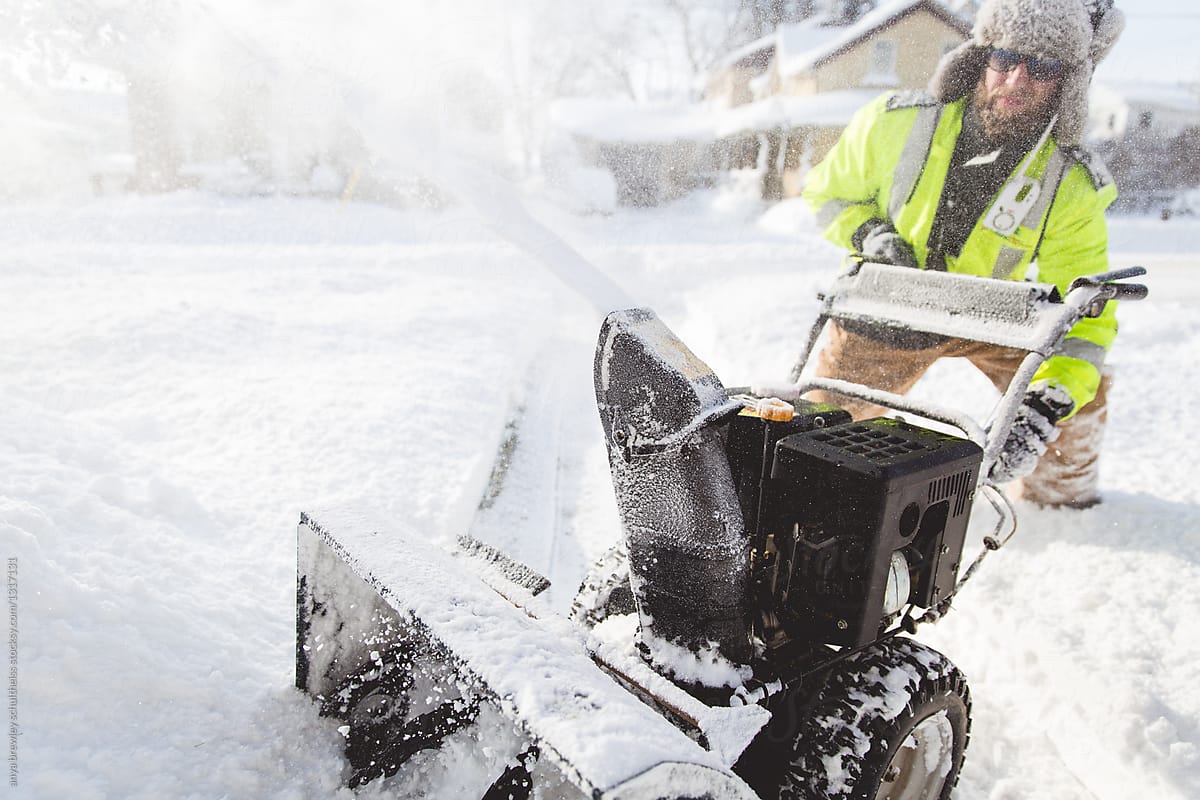 Man using a snow blower to remove large amounts of snow