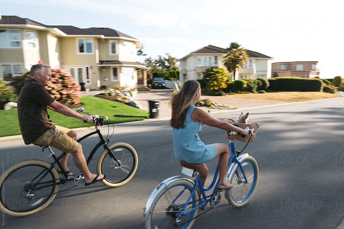 Healthy, active couple enjoying life riding cruiser bikes in sun