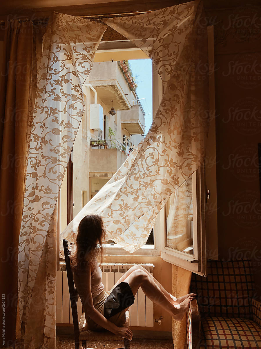 A Woman Sitting In Front Of Window By Stocksy Contributor Anna Malgina Stocksy