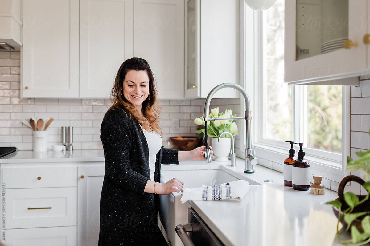 Woman finding joy cleaning the kitchen