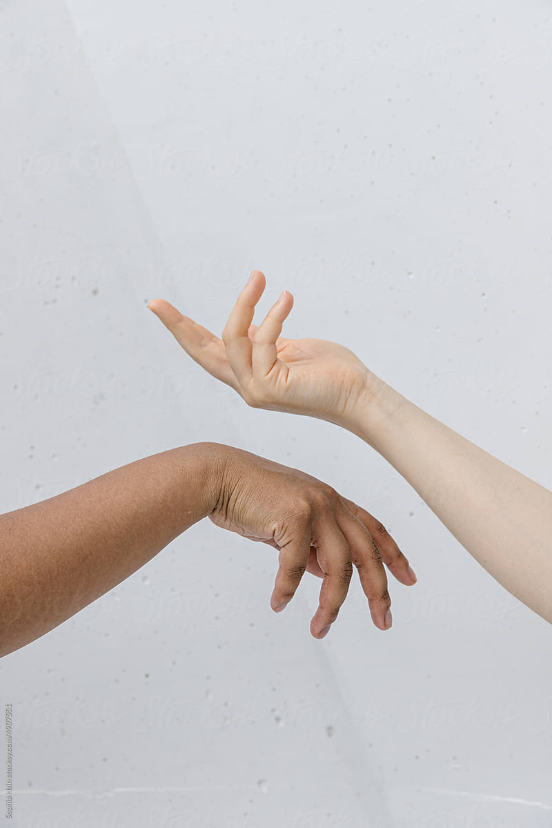 Two pairs of hands reaching out to one another