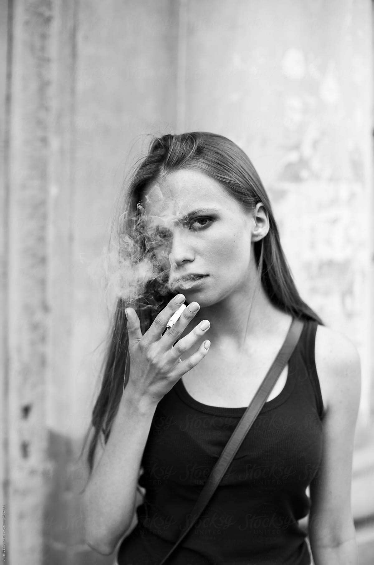young woman smoking outdoors