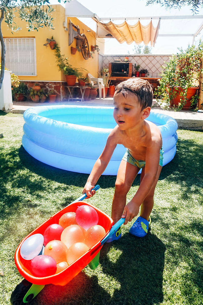 Boy with kid cart of water balloons