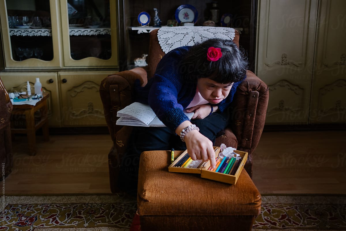 Woman With Down\'s Syndrome Taking A Pen From A Pencil Case