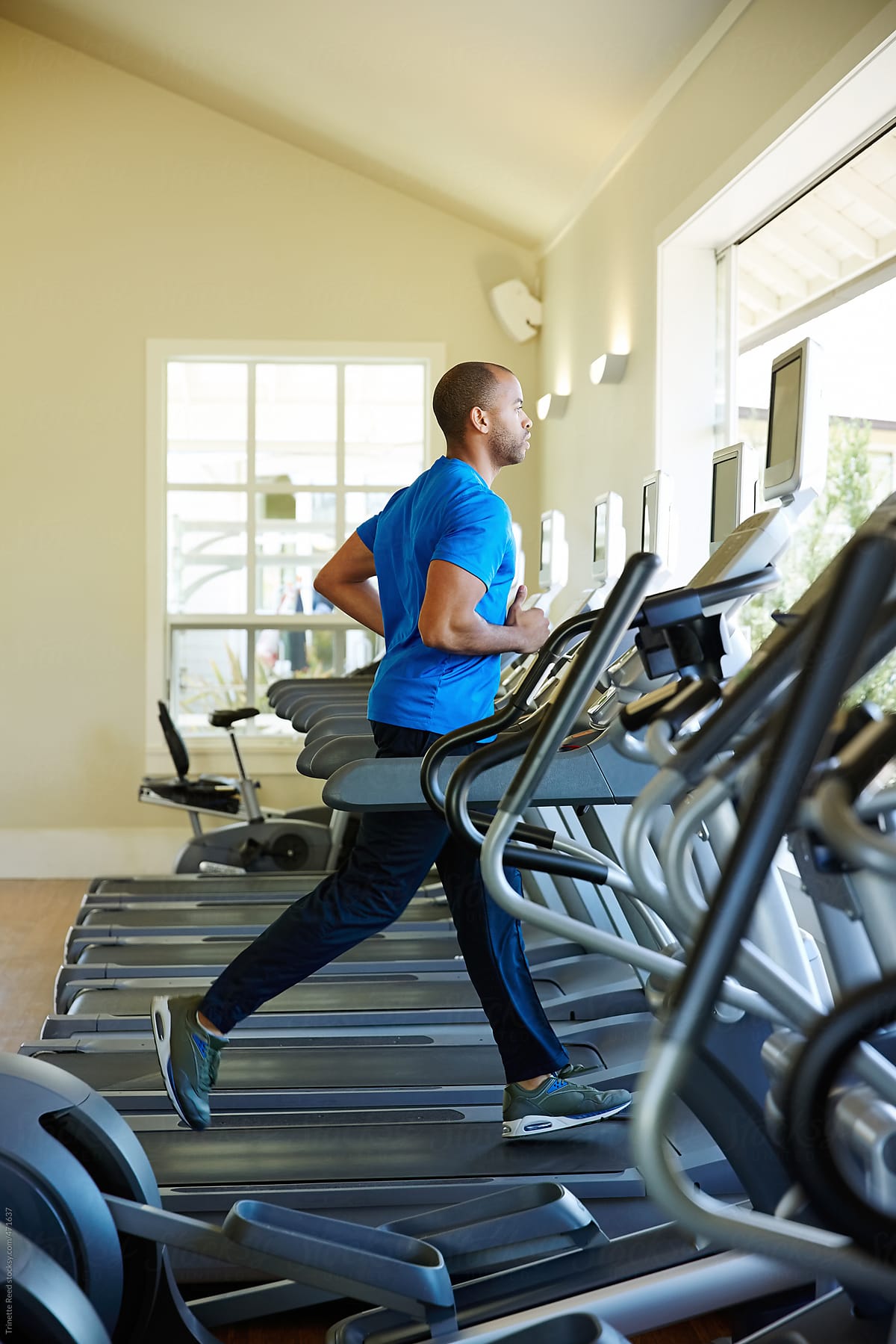 Man working out at gym at luxury resort on treadmill