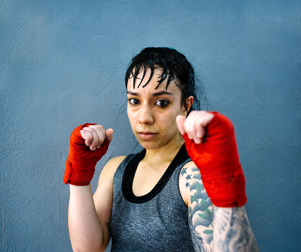 Portrait Of Boxer Woman Posing With Red Gloves And Tattoos.