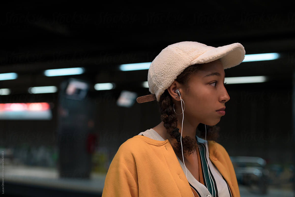 Teenager with earphones at the station